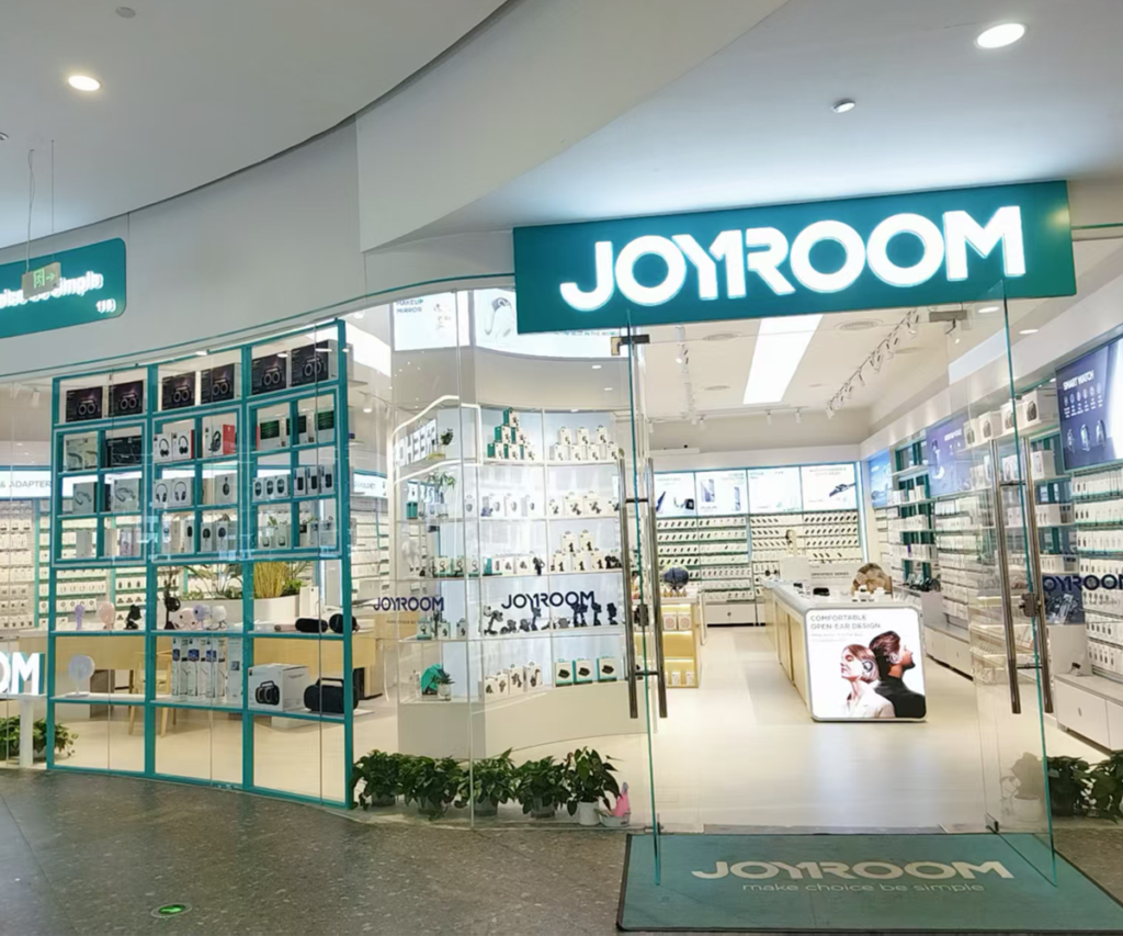 JOYROOM retail store front with illuminated logo glass entrance and organized accessory display racks