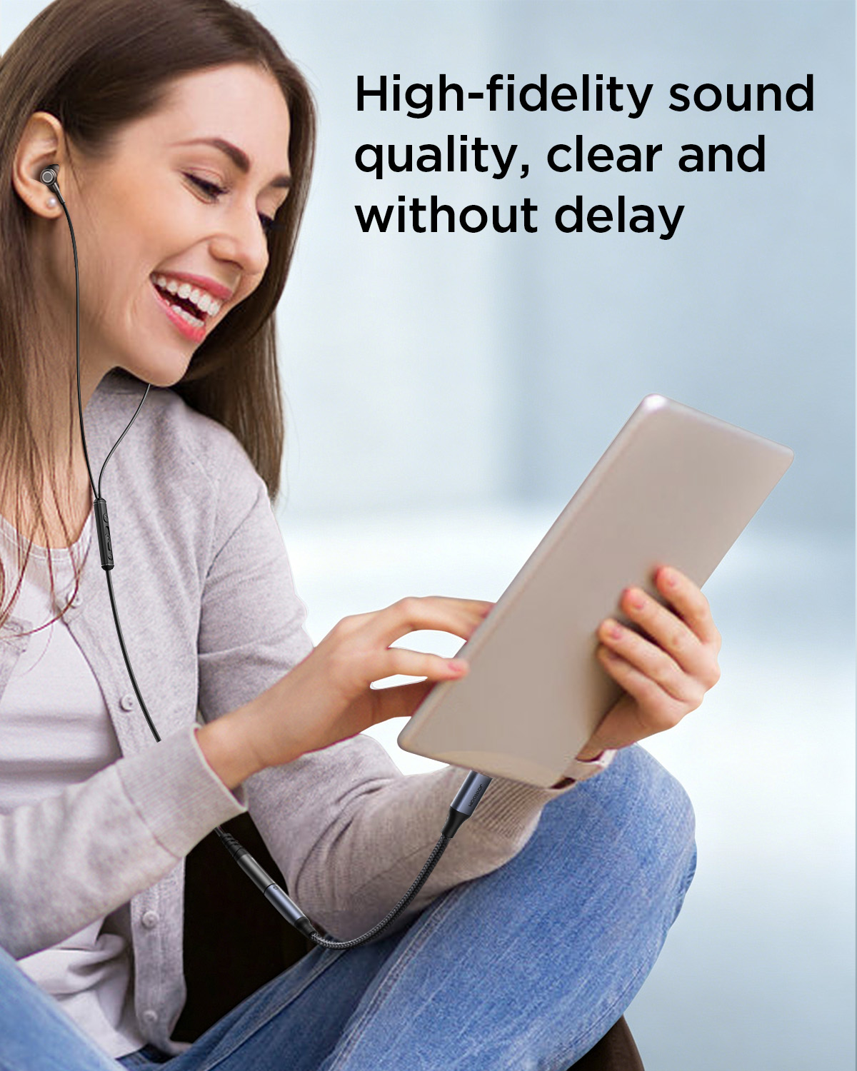 A woman smiling while listening to music on a tablet using the JOYROOM SY-C01 Type-C to 3.5mm audio adapter and wired earphones. Text reads 'High-fidelity sound quality, clear and without delay'.